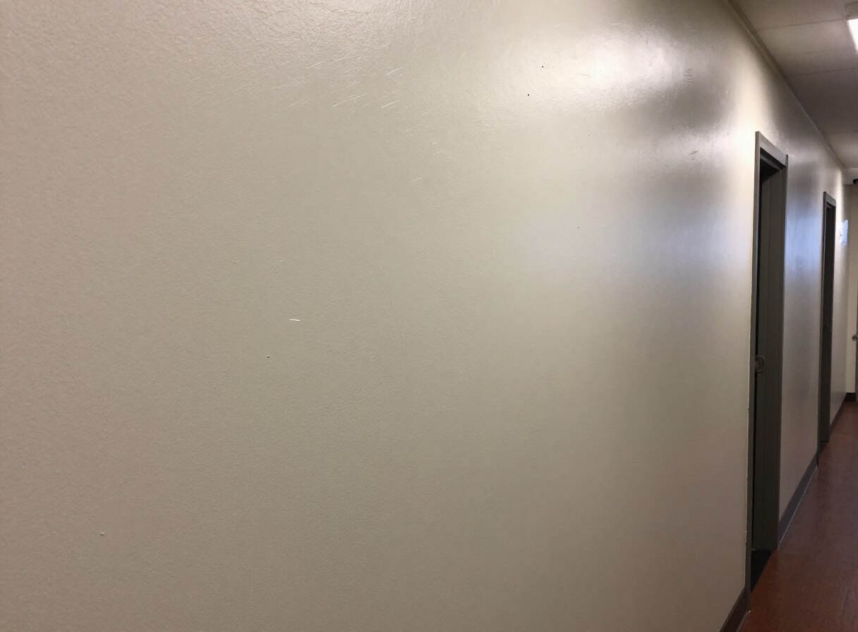 Damaged hallway wall in a West New York NJ multifamily building before repair