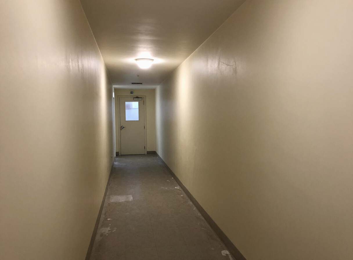 West New York apartment hallway before painting with scuffed dingy walls